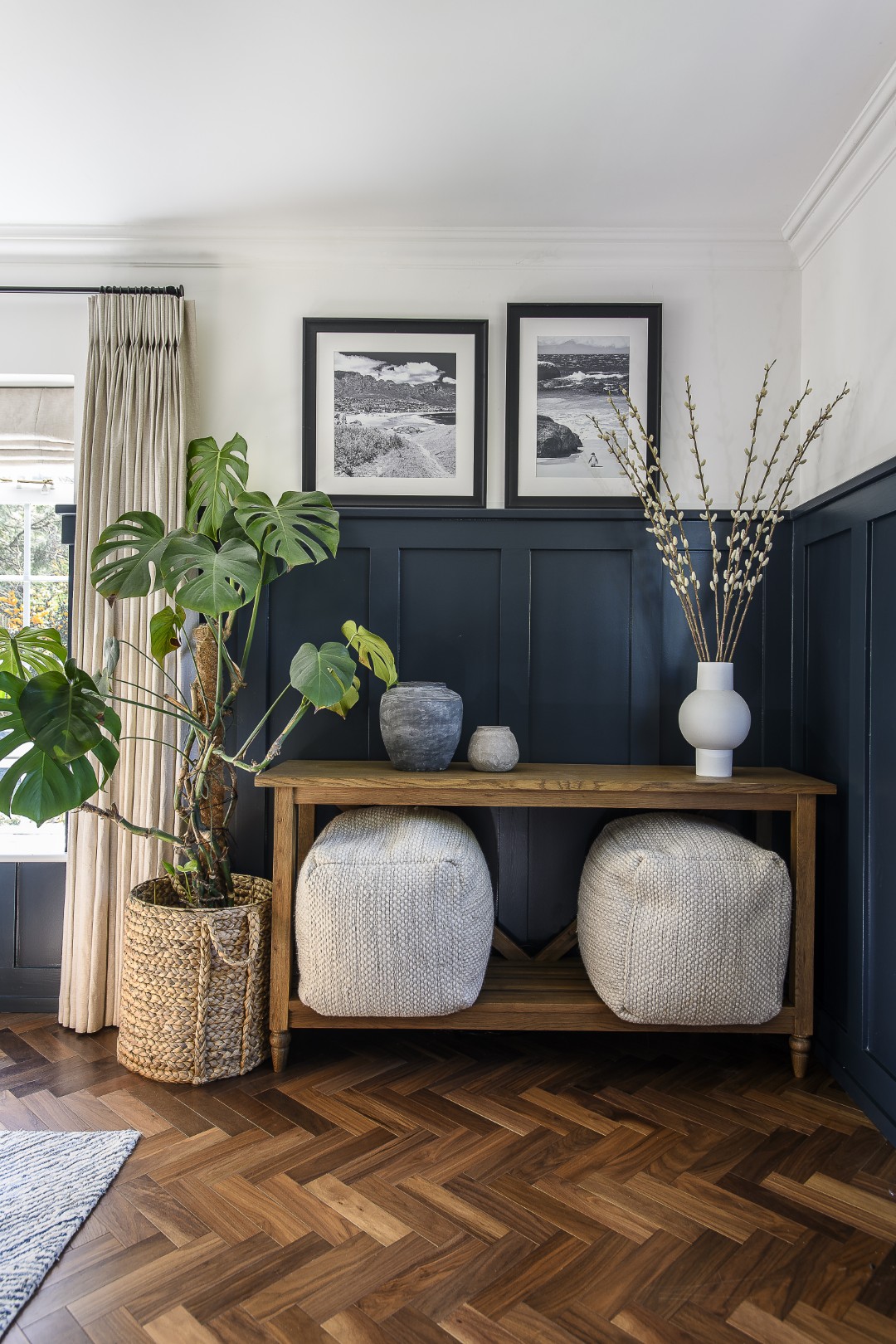 In the living room, softly patterned grey furnishings offset the deep navy sofa, bringing a contrast to the room that echoes the open-plan living space next door