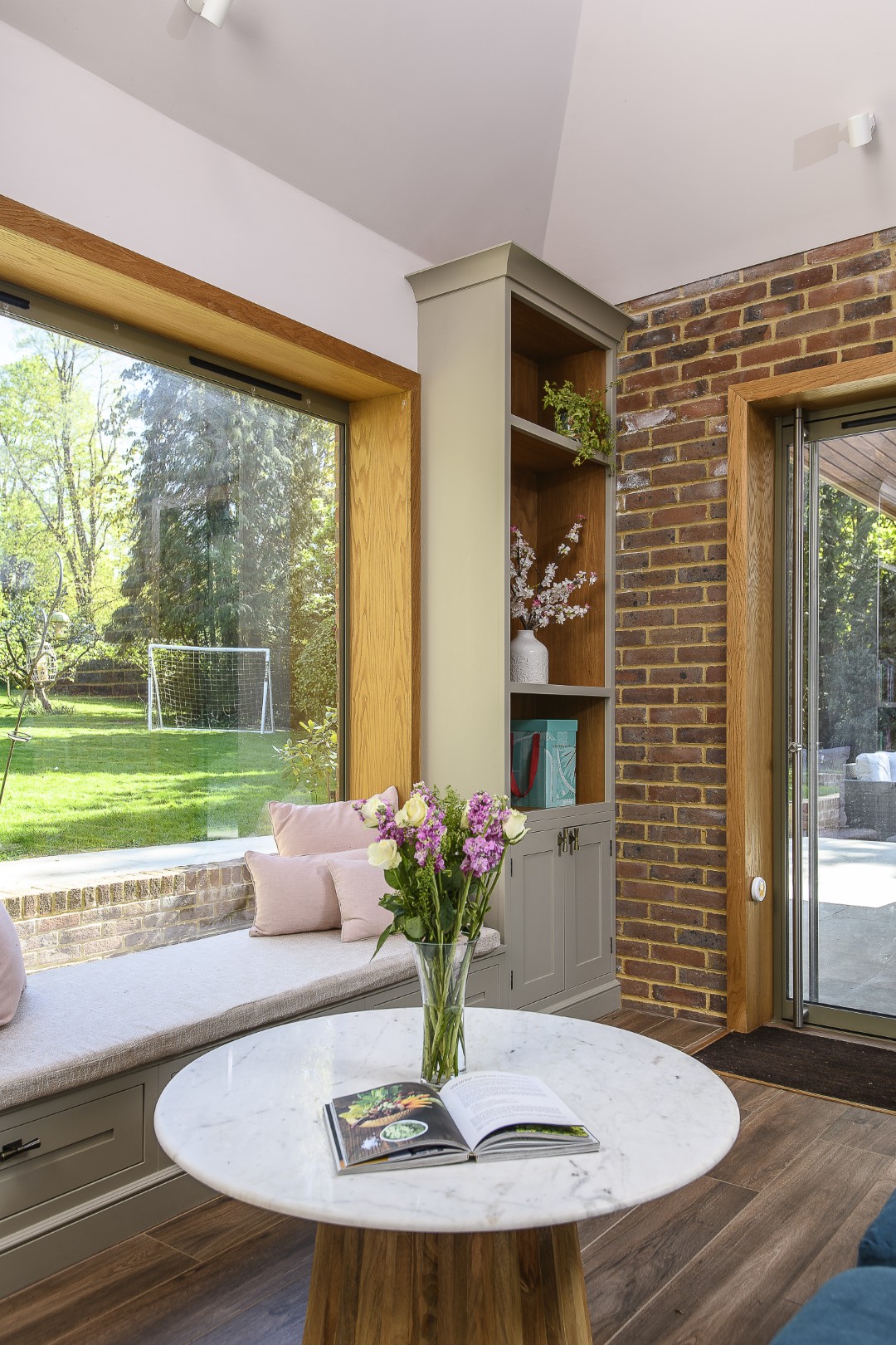 Large windows allow plenty of natural light into the cosy snug area by the kitchen