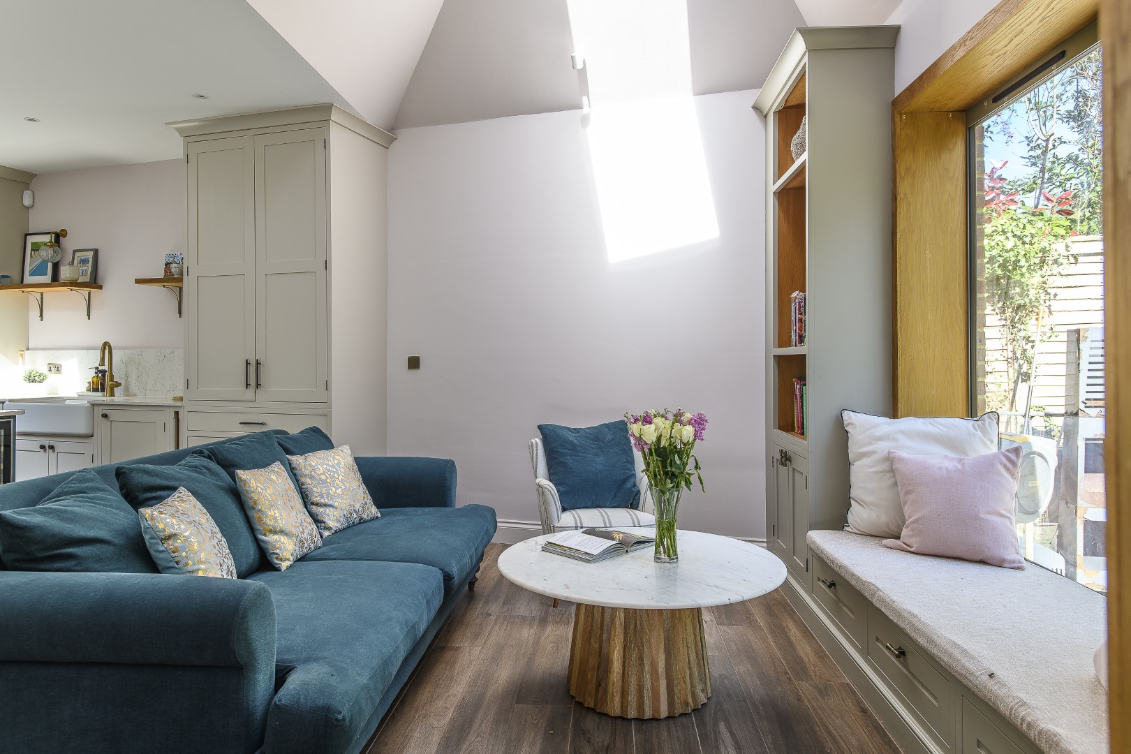 Large windows allow plenty of natural light into the cosy snug area by the kitchen