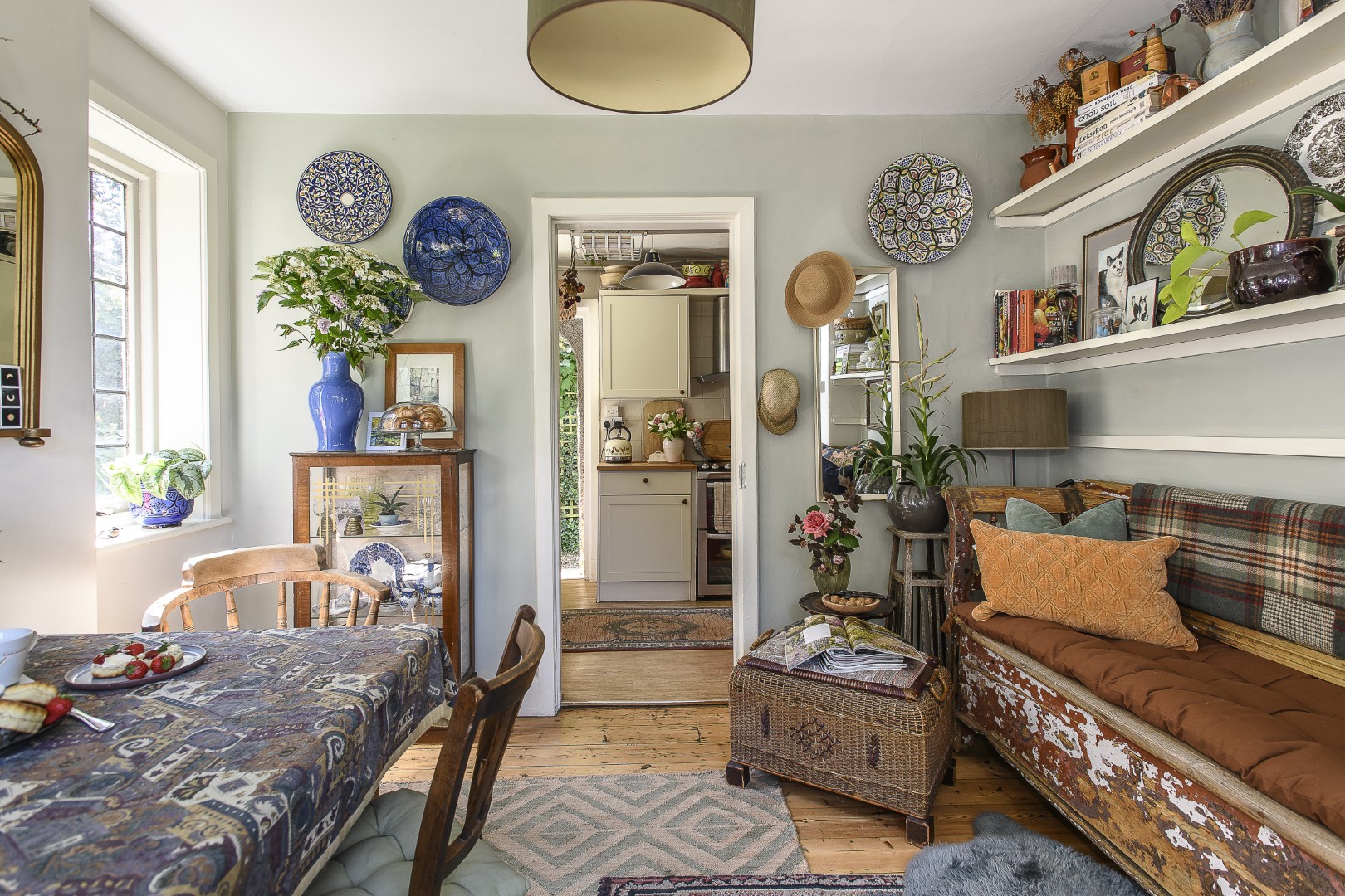 The dining room/second reception room leads through to the kitchen and through again to the ground floor bathroom, all filled with greenery and Aga’s carefully curated collections