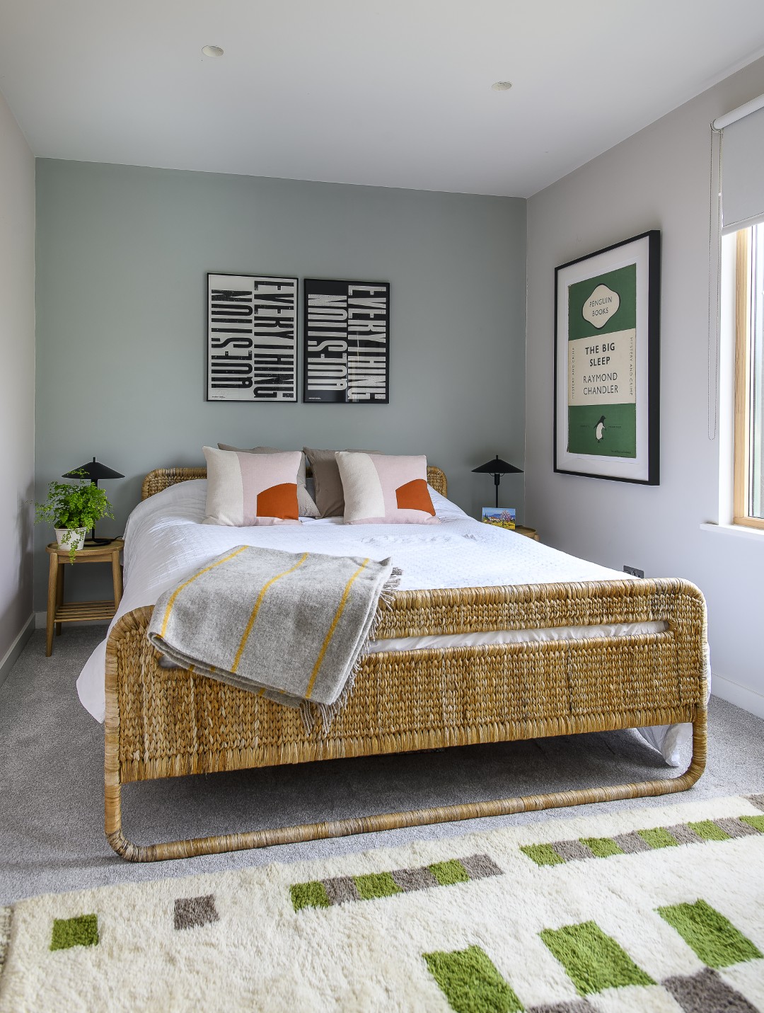 Art plays a key role not only downstairs, but in the bedrooms on the first floor, too. Here, in a guest room, typography prints by Antony Burrill (anthonyburrill.com) are hung behind the bed.