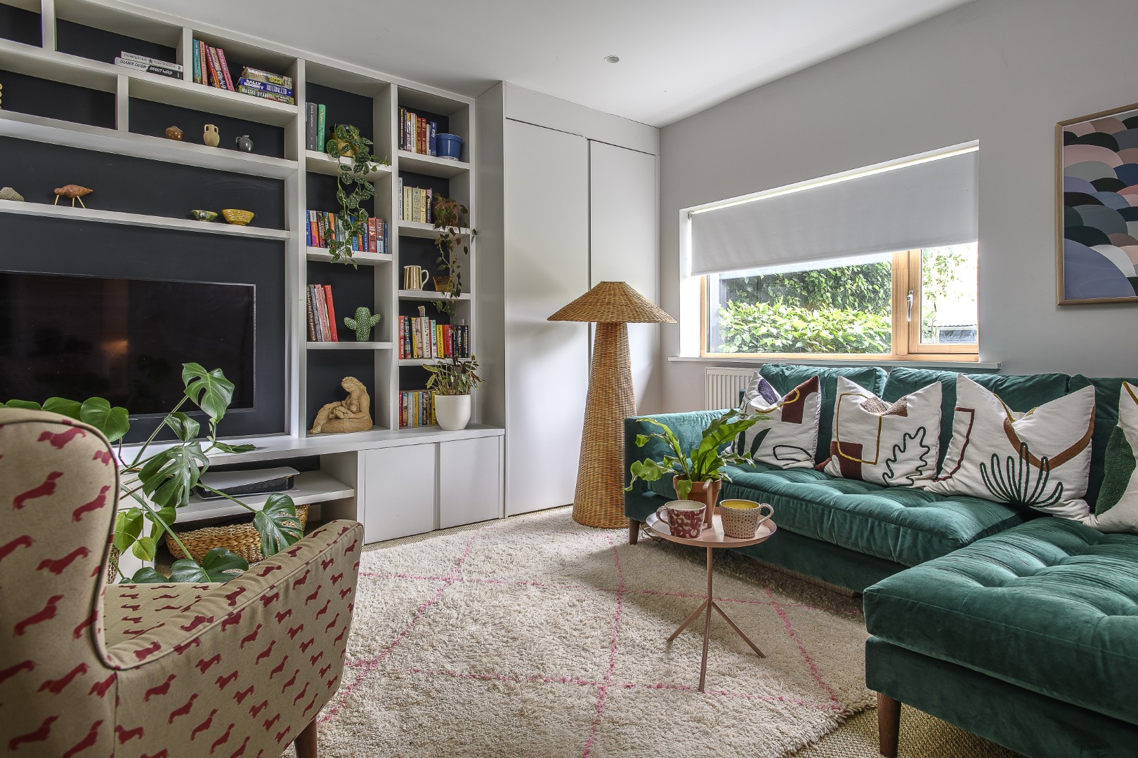 In the snug downstairs, which Tracey says is very much her daughter Tilly’s domain, a bright-green sofa sits on a deep Moroccan rug, the whole space also made more intimate (and practical) with bespoke shelving.