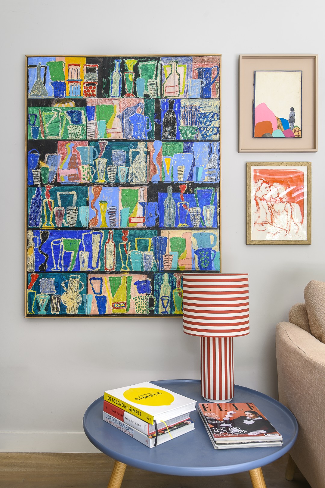 On top of a Muuto blue side table sits a candy-stripe table lamp from Heal’s. The large painting above was bought from McCully & Crane .