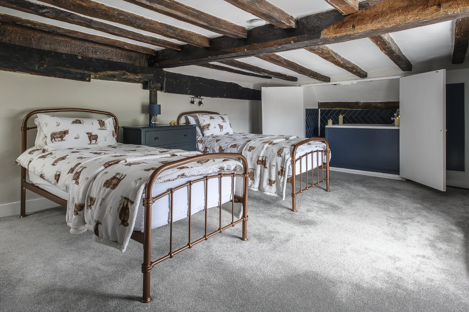 Concealed when not in use by wardrobe doors, a bath tub has been fitted into the eaves of the children’s room