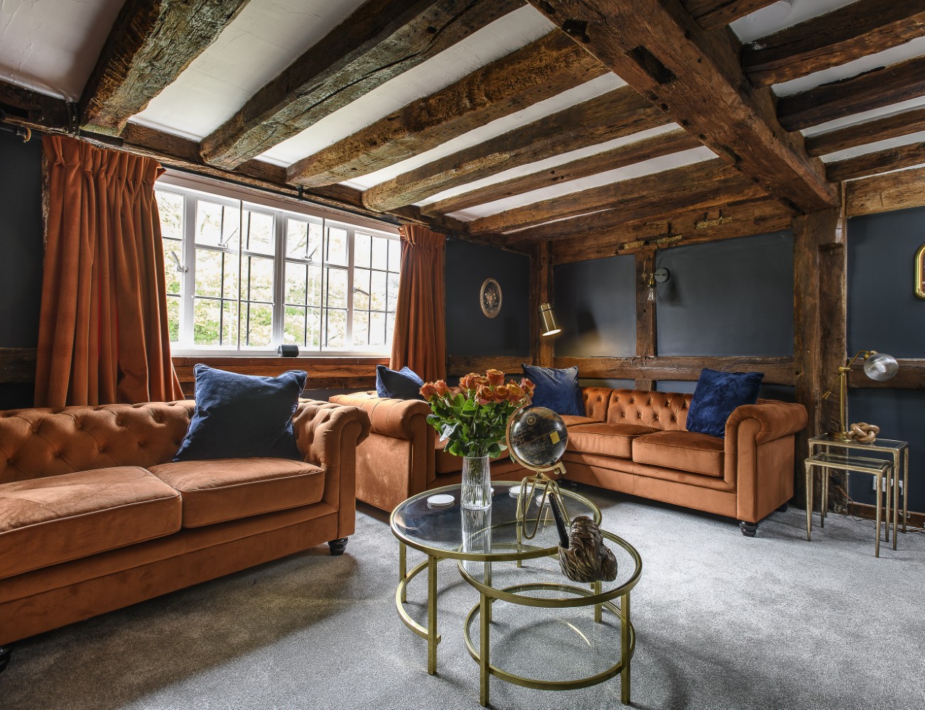 The heavily beamed sitting room, which leads into the games room (above) offers a cosy retreat to the rear of the house and celebrates the building’s Medieval origins