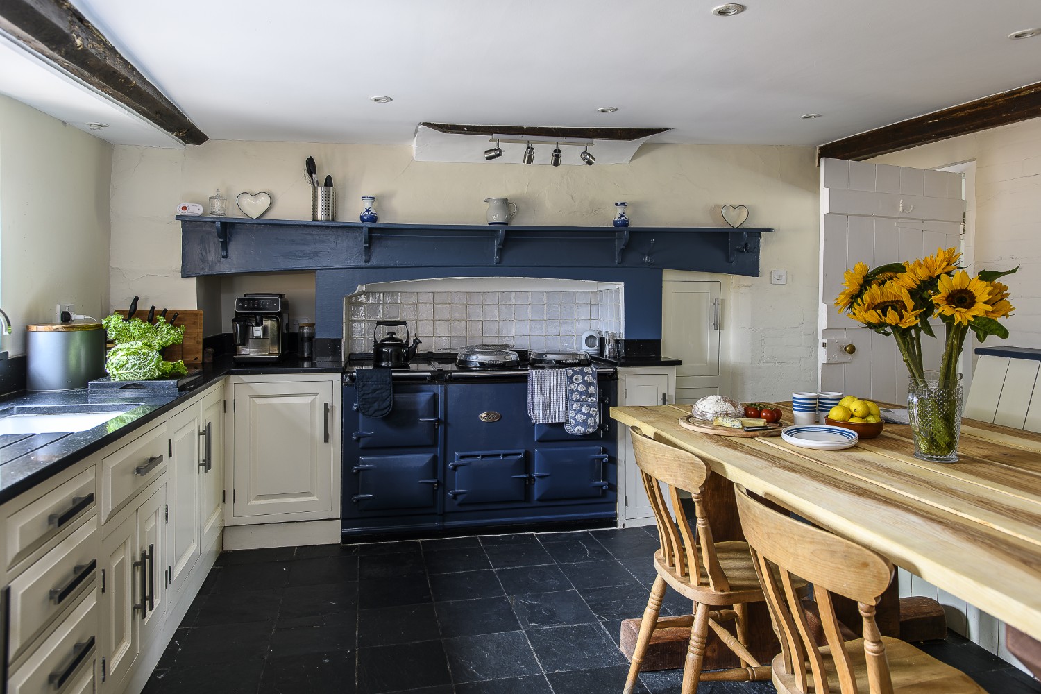A deep blue Aga takes centre stage in the kitchen.