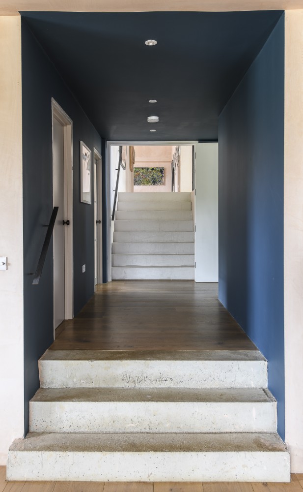 The large doors at the end of a deep blue corridor that leads to the gallery’s rooms