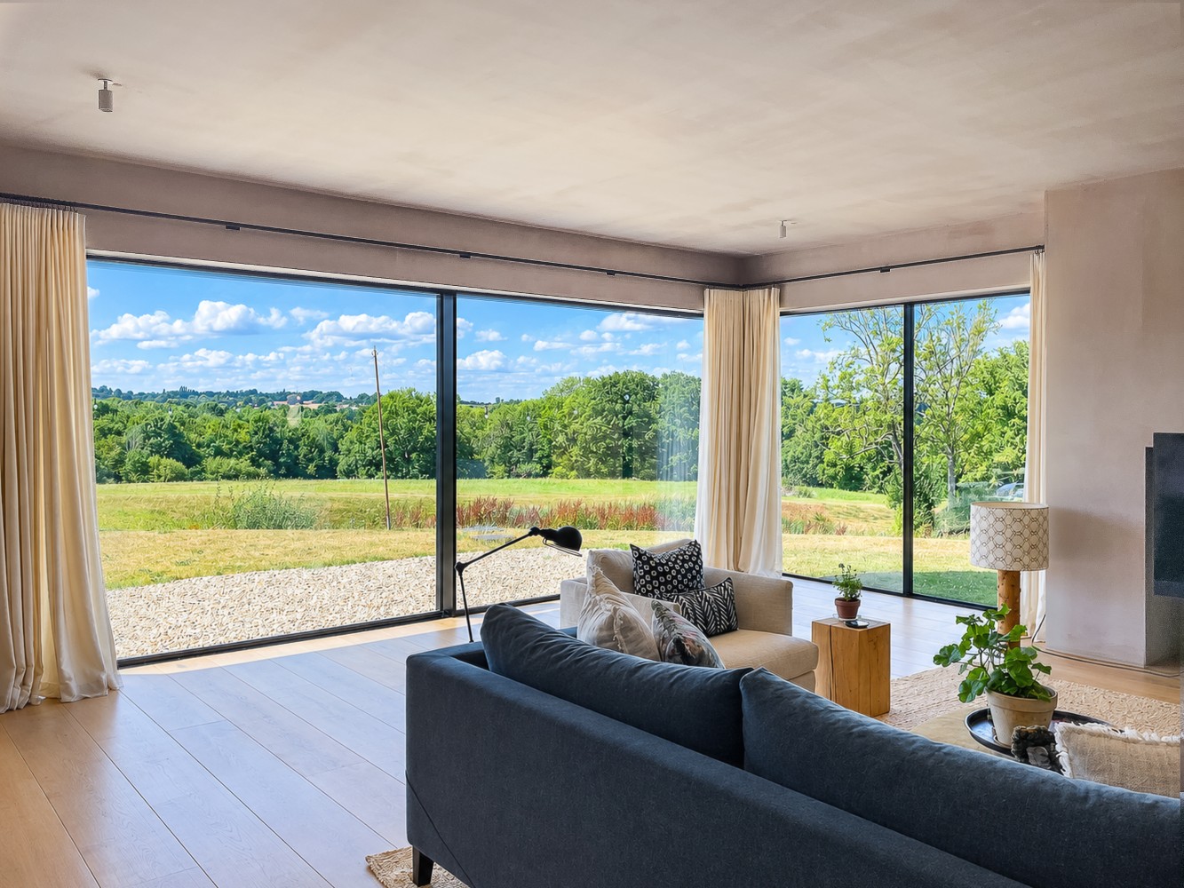 Large Crittall-style windows connect the rooms with the landscape.