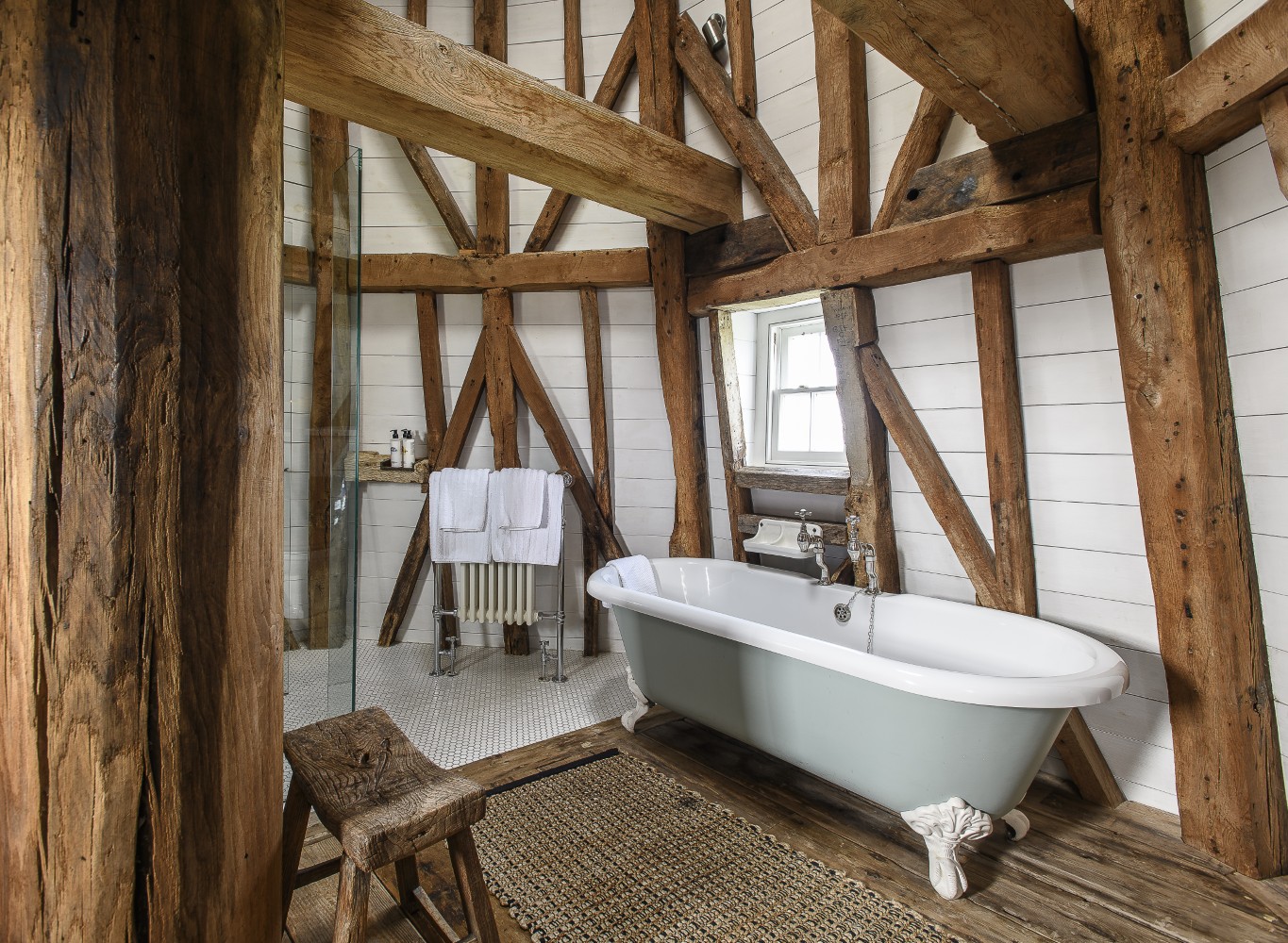 Through meticulous thought and planning, the shower ‘floats’ in the bathroom at the top of the Mill, its frameless structure almost completely transparent