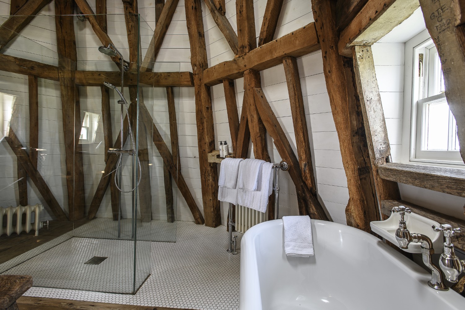 Through meticulous thought and planning, the shower ‘floats’ in the bathroom at the top of the Mill, its frameless structure almost completely transparent
