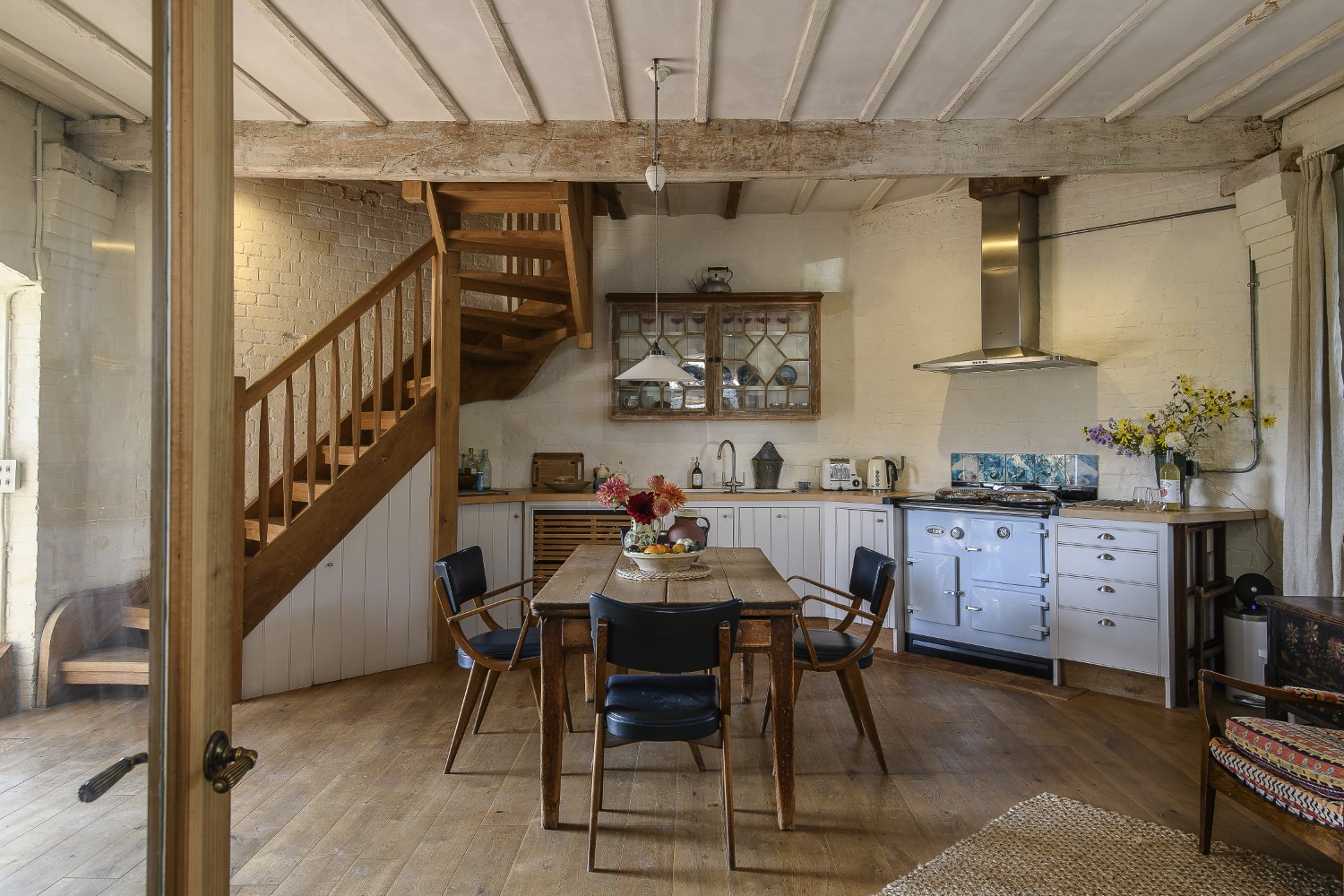 The ground floor kitchen and living area leads through to a separate building that houses the bedroom, linked by a glazed walkway