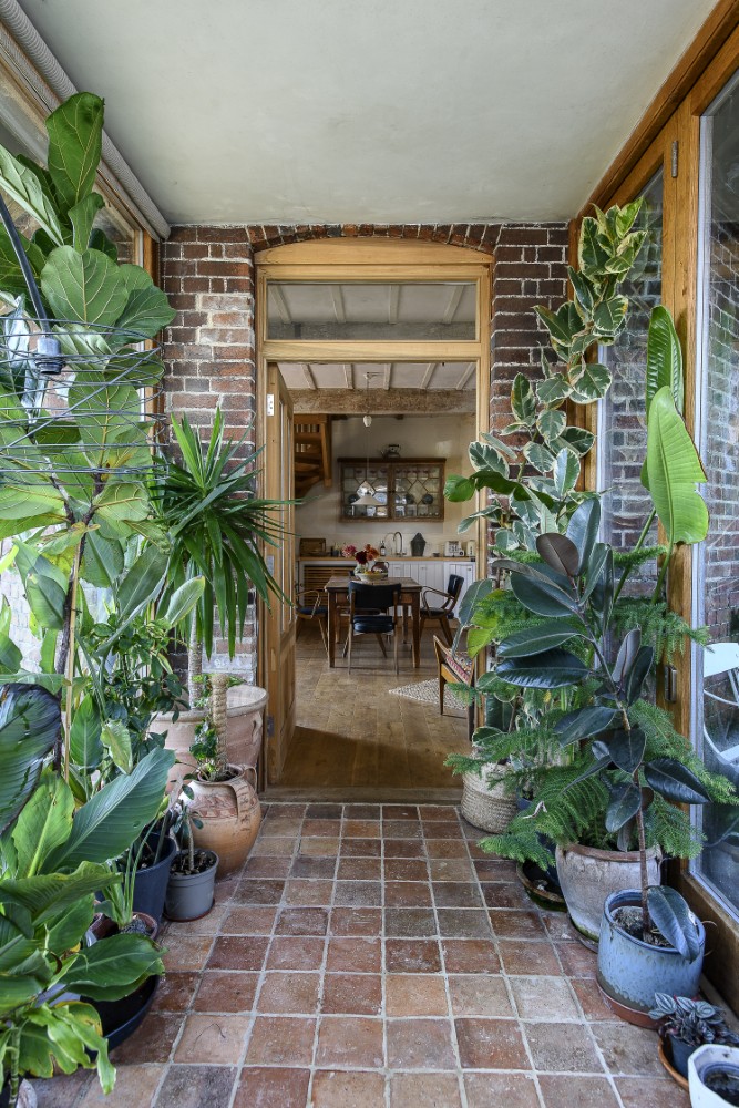  The building’s industrial past is softened with plenty of house plants and fresh blooms throughout