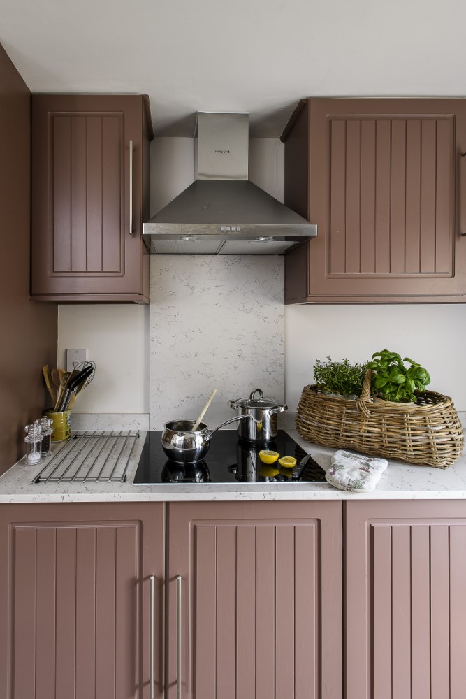 Sarah repainted and refreshed the kitchen units with Nether Red by Little Greene.